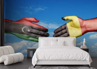 Belgium and Libya country handshaking with flags, consensus concept international co-operation illustration Wall mural