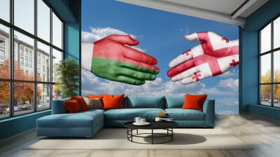 Georgia and Madagascar country handshaking with flags, consensus concept international co-operation illustration Wall mural