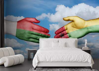 Guinea-Bissau and Madagascar country handshaking with flags, consensus concept international co-operation illustration Wall mural