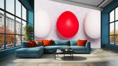 Big easter red egg with two white egg on a shine silver background. Concept for greeting card. Wall mural