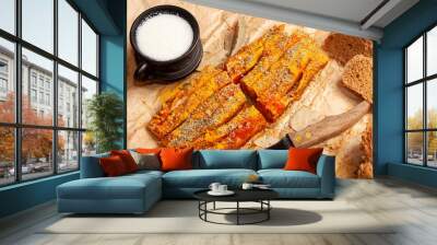 Ukrainian tradition homemade food - strips smoked bacon fat with bread and cup of sour milk - on craft paper Wall mural