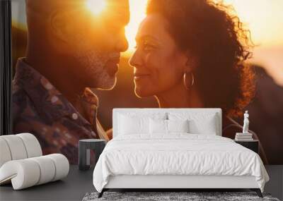 a couple sharing a tender moment as the sun sets behind them casting a warm glow on their faces. Wall mural