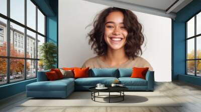 A teenage girl exuding confidence and happiness, framed by a pristine, well-lit studio environment. Wall mural