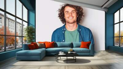 Handsome good-looking smiling male posing for advertisement wears denim shirt, isolated on white wall with copy space for your informational text. People and emotion concept Wall mural