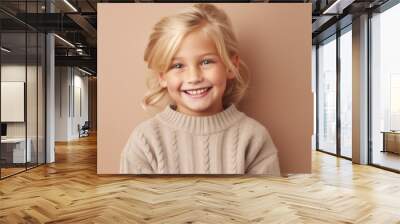 Portrait of a happy blonde kid, donning neutral clothes, and smiling against a soft beige studio backdrop. Generative AI Wall mural