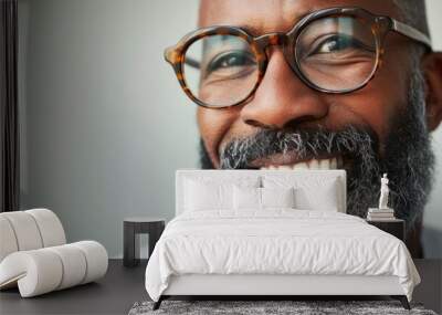 Smiling man with glasses and gray beard. Wall mural