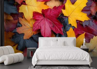 A vibrant close-up of autumn leaves in rich red, orange, and yellow hues on the ground Wall mural