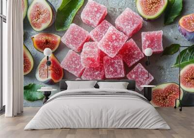 Assorted fig candies arranged with fresh figs and leaves on a textured background Wall mural