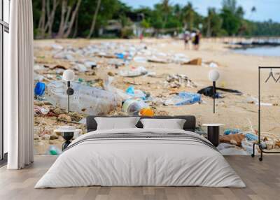 Beach pollution. Plastic bottles and other trash on the beach Wall mural