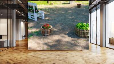 A park with a bench and two flower pots Wall mural