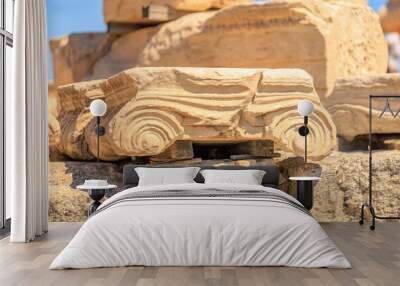 A stone carving of a car is sitting on top of a pile of rocks, Acropolis in Athens Wall mural