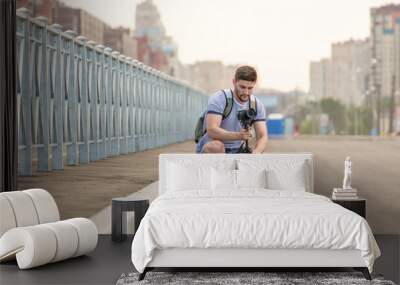 Man with camera on tripod Wall mural