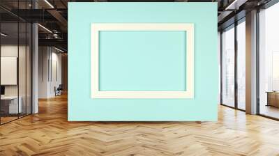 Picture frame flat lay on textured pastel colored paper background Wall mural