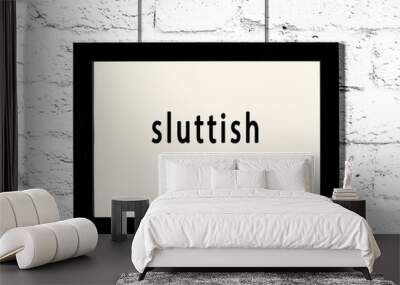 Black frame hanging on white brick wall with inscription sluttish Wall mural