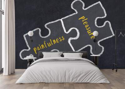 Chalk drawing of two puzzles with words painfulness and pleasure Wall mural