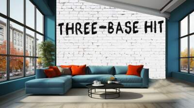 White wall with black paint inscription three-base hit on it Wall mural