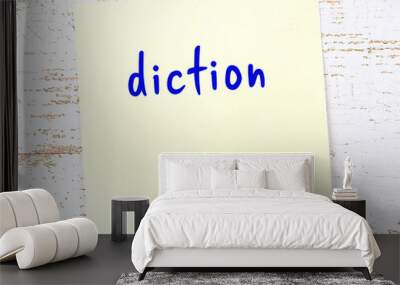 Yellow sticky note on wooden wall with handwritten word diction Wall mural