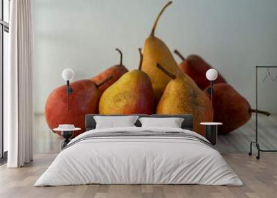 Group of pears edible fruits, tasty ripened red yellow fruit on the table Wall mural