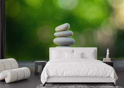 Harmony and balance, cairns, simple poise pebbles on wooden table, natural green background, simplicity rock zen sculpture Wall mural