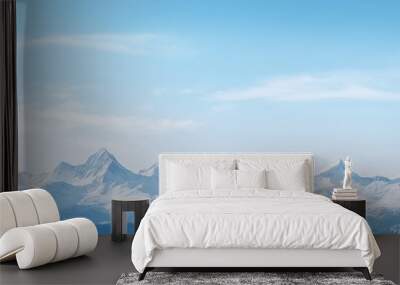 a snowy mountain tops and blue sky Wall mural