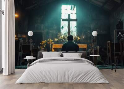 A solitary figure kneels in prayer before an altar in a dimly lit chapel. Wall mural