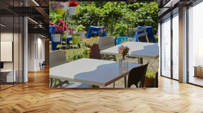 A table in a park under a tree on a cloudy summer day. Wall mural