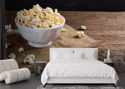 Air salty popcorn.A bowl of popcorn on a wooden table.Salt popcorn on the wooden background .  With space for text.Top view.popcorn texture.Chees . Wall mural