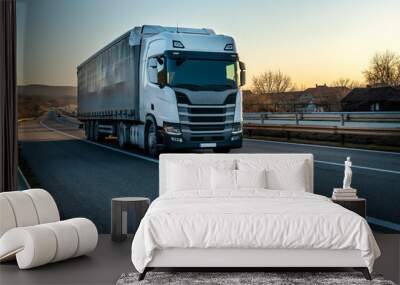 Big semi trailer truck on a highway driving at bright sunny sunset. Transportation vehicle Wall mural