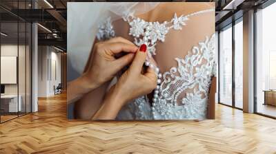 Bridesmaid preparing bride for the wedding day. Fastening a whit Wall mural