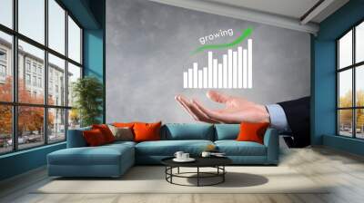 Business man holding holographic graphs and stock market statistics gain profits. Concept of growth planning and business strategy. Display of good economy form digital screen. Wall mural