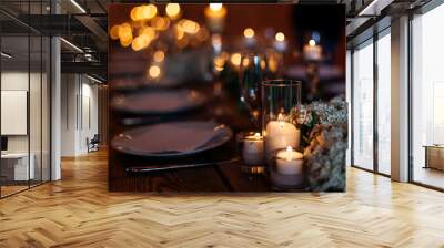 Candles on wedding table set on a beautiful lit background. Forget-me-not flowers lit by candles on wooden table Wall mural