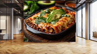 Cheesy enchiladas with avocado and cilantro on a rustic wooden table Wall mural