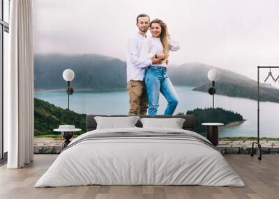 Couple hugging and enjoying the breathtaking panorama of the Azores, Portugal. Wall mural