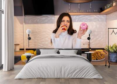 Dieting Concept. Young Woman Choosing Between Fruits And Sweets Wall mural