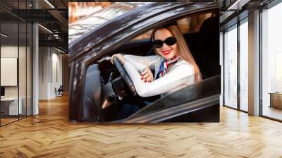 Fashion girl driving a car in a white shirt and sunglass. Stylis Wall mural