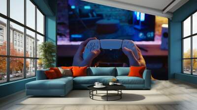 Hands of a person holding a white console game controller on the background of a TV with a game, selective focus
 Wall mural