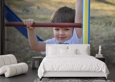 Happy boy playing on the playground. Smiling child play in park Wall mural