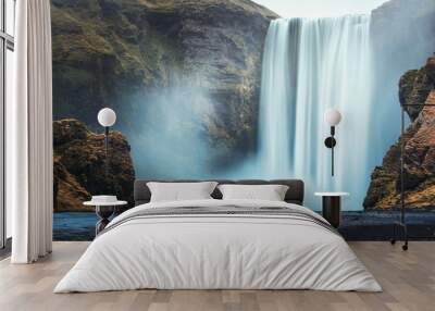 Couple of tourist near famous Skogafoss waterfall, Iceland Wall mural