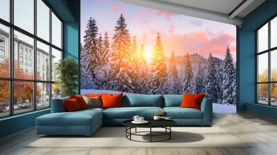 Fantastic orange winter landscape in snowy mountains glowing by sunlight. Dramatic wintry scene with snowy trees. Christmas holiday background Wall mural