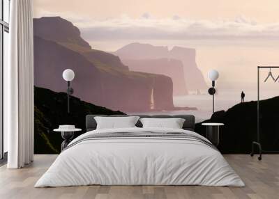 Man silhouette on background of famous Risin og Kellingin rocks and cliffs of Eysturoy and Streymoy Islands seen from Kalsoy Island. Faroe Islands, Denmark. Landscape photography Wall mural