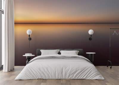 Tranquil minimalist landscape with smooth surface of the pink salt lake with calm water with horizon with clear sky in sunset time. Simple beautiful natural calm background Wall mural