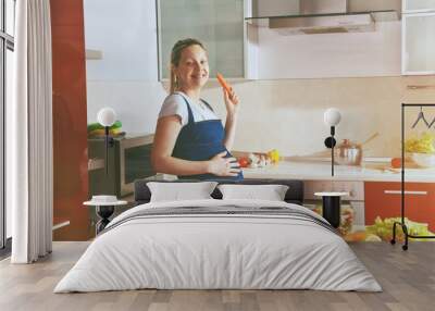 happy pregnant woman on kitchen making healthy salad Wall mural