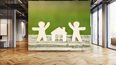 little wooden men and house on natural background. Symbol of construction, family, sweet home concept Wall mural