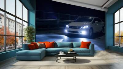 Car with xenon headlights fast drive on road at nigh Wall mural