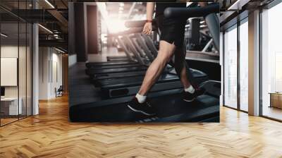 People walkingin machine treadmill at fitness gym club Wall mural