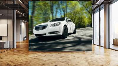 White car fast drive on asphalt road at daytime Wall mural