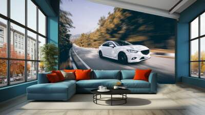 white car speed driving on asphalt road at daytime Wall mural