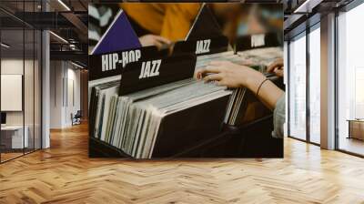 Woman is choosing a vinyl record in a musical store Wall mural