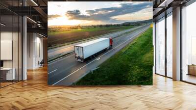 Large Transportation Truck on a highway road through the countryside in a beautiful sunset Wall mural