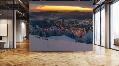 Panorama winter old City. Banska Stiavnica, Slovakia. Church at the top of the hill. Light of houses in the valley Wall mural